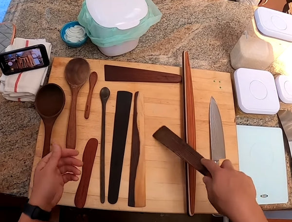Kenji showing his Earlywood utensils on countertop
