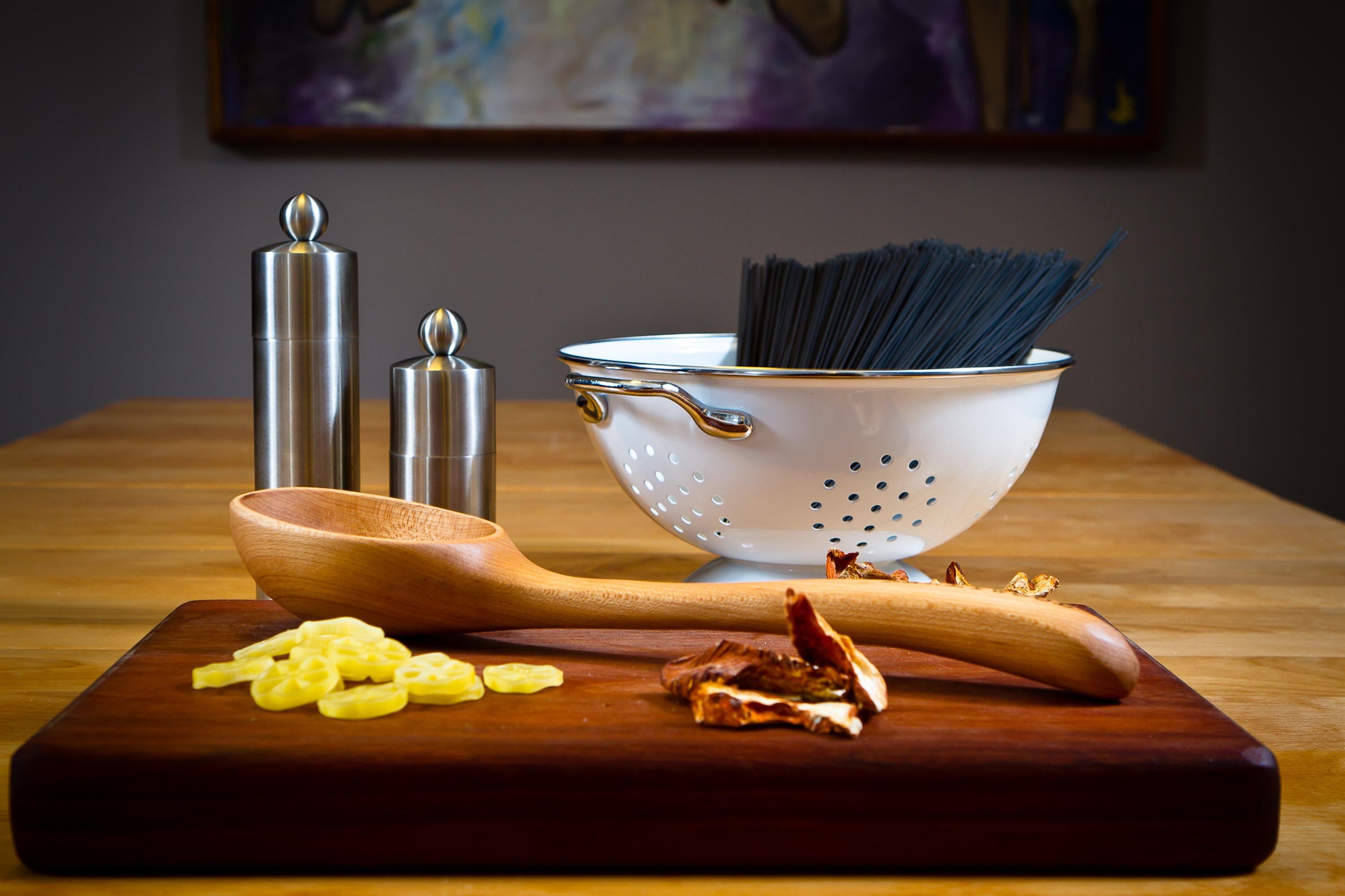 Fanned display of a variety of different wooden kitchen utensils