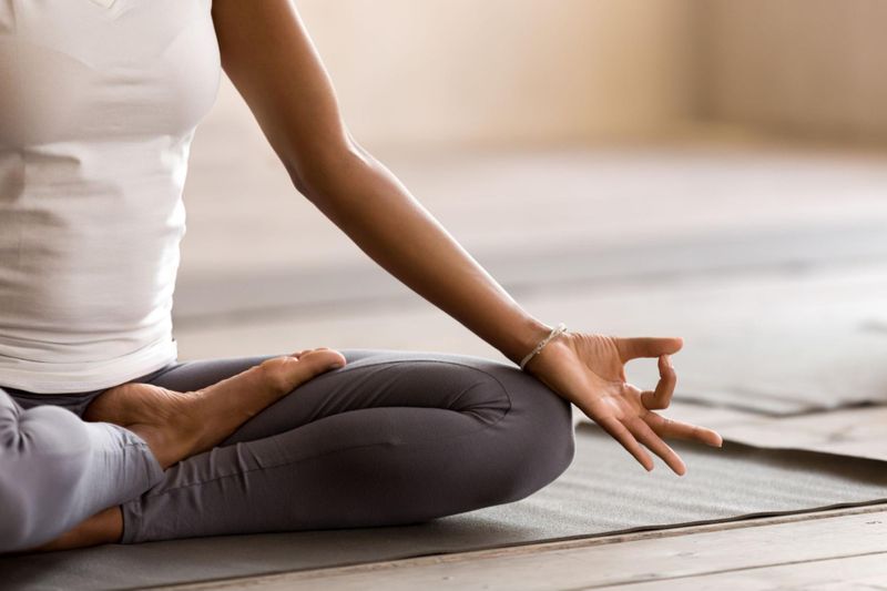 Young woman meditating to reduce insomnia symptoms