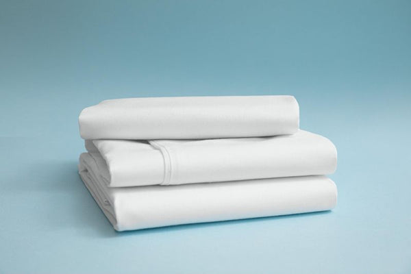 A stack of neatly folded white bamboo rayon bedsheets