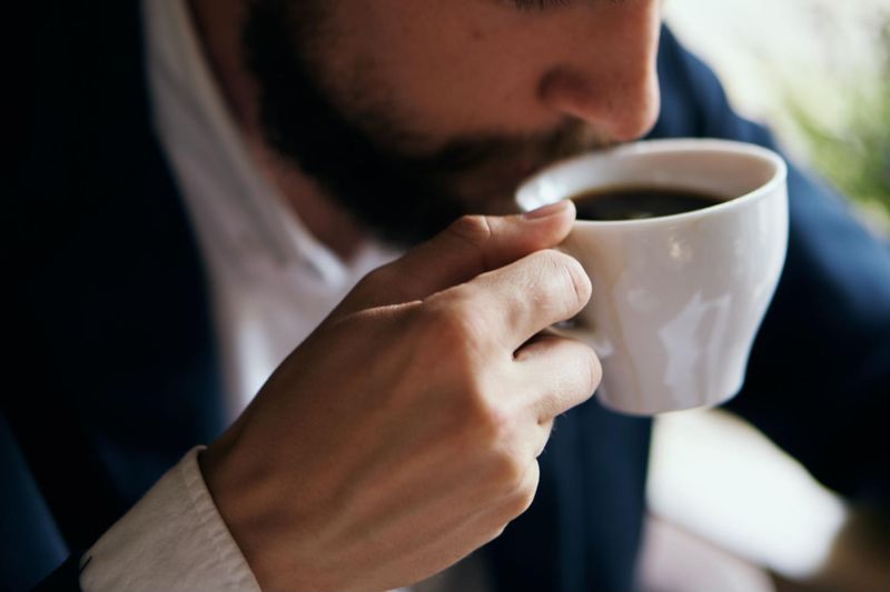 Young professional drinking coffee before bed