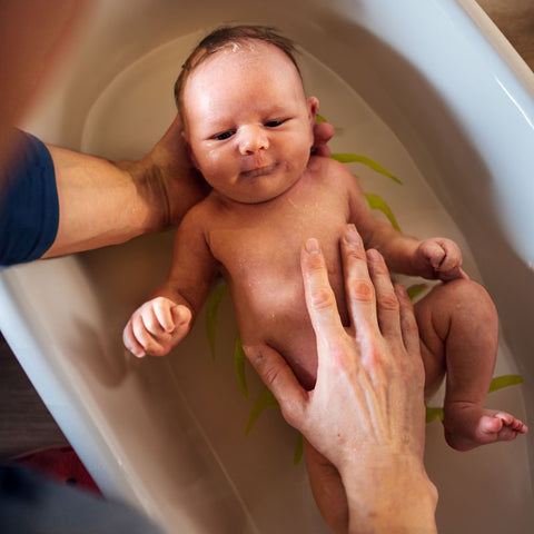 newborn in baby bath