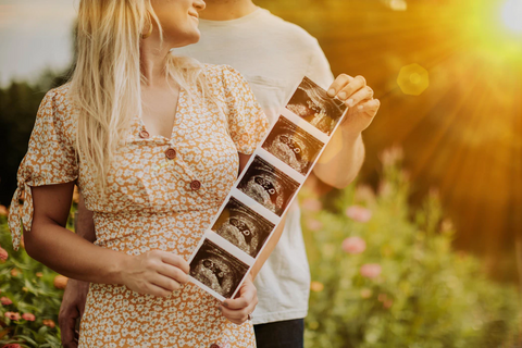 man and woman holding ultrasound photo