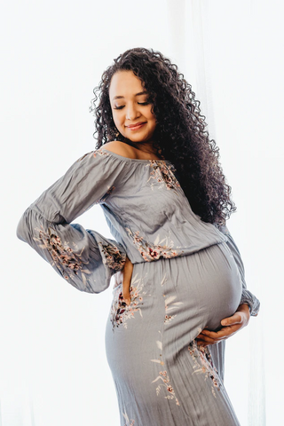 pregnant woman in off-the-shoulder dress