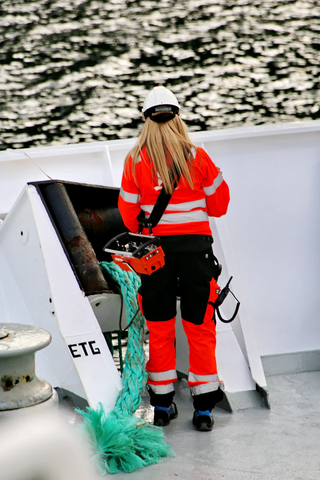 woman in safety orange on a boat