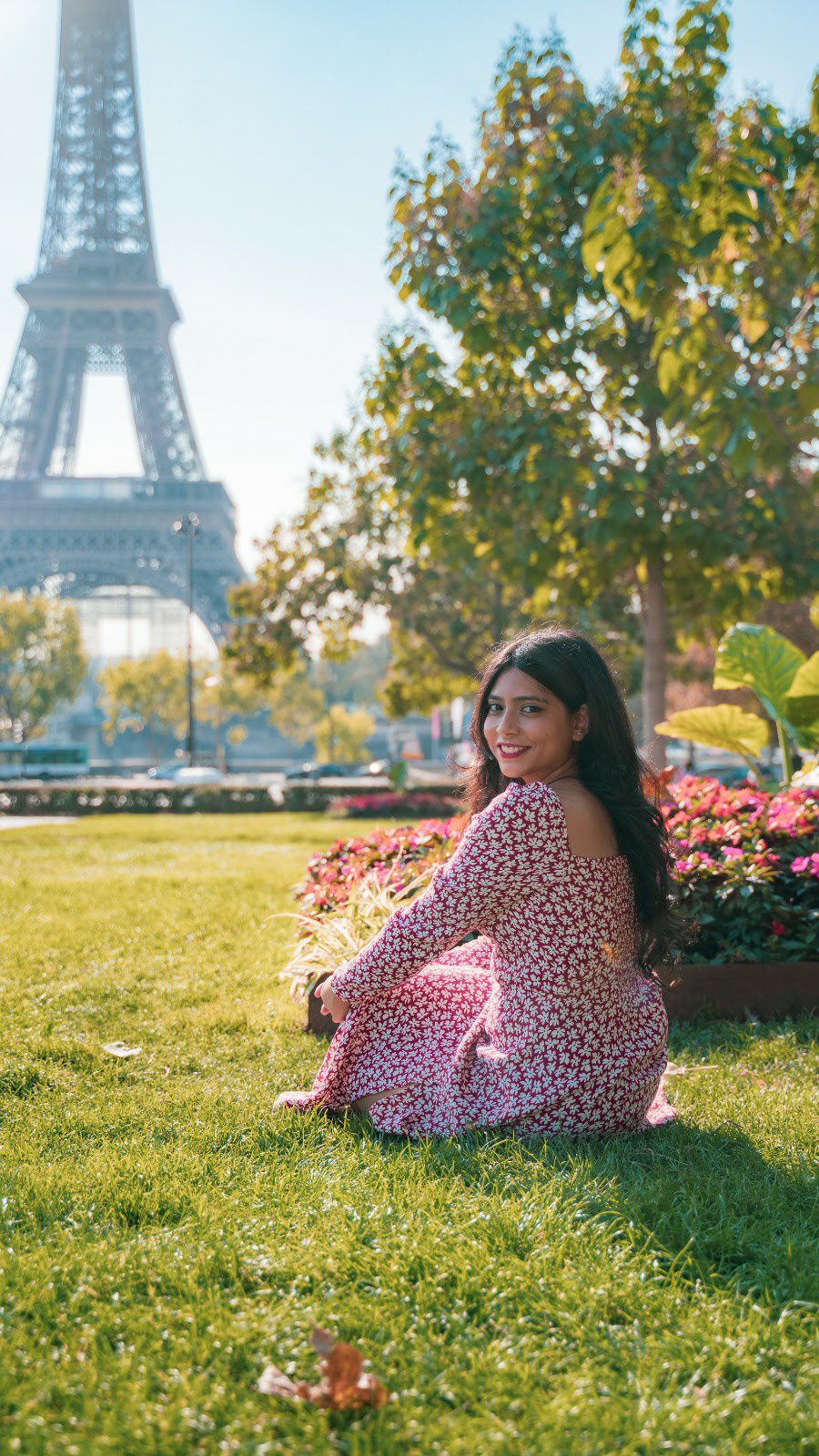 Girl in red floral Reformation dress at Eiffel Tower