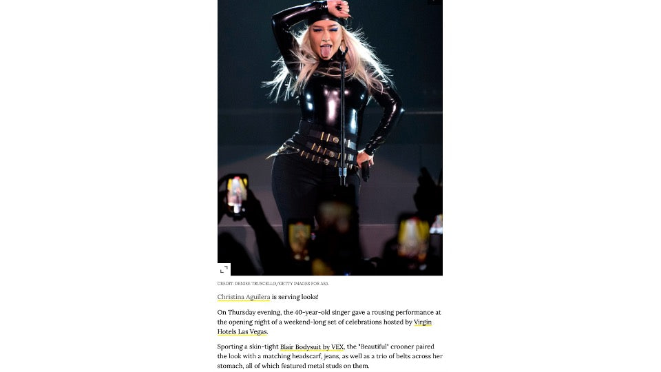 Christina Aguilera wearing black Vex latex bodysuit and bandana performing on stage