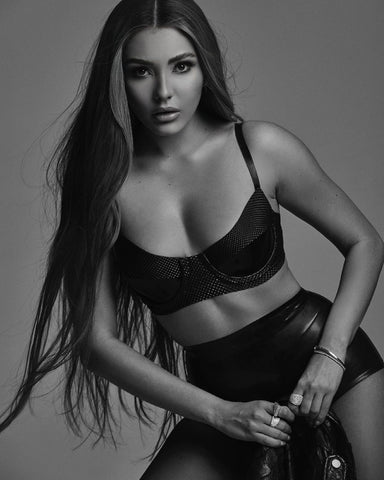 Black and white photo of a women posing in Vex Streamline Knickers and black pyramid bra