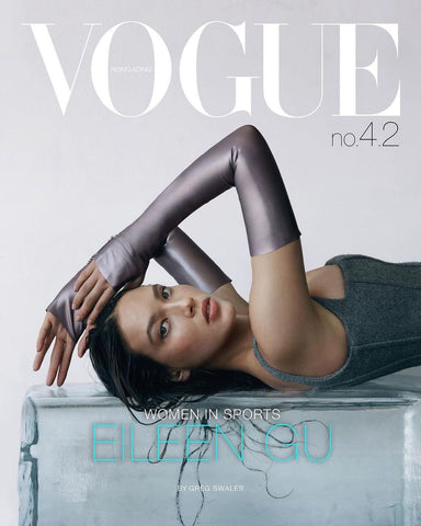 Model laying on a table facing the camera wearing Vex's Opera Knuckle Gloves for the cover of Vogue
