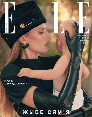 Model wearing black Vex Laced Opera Gloves holding a baby on the cover of Elle Magazine Russia
