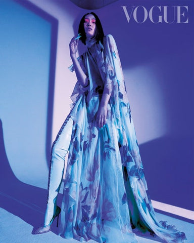 Model for Vogue Taiwan wearing blue vex clip leggings with a blue floral gown against a blue filtered backdrop