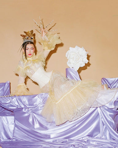 Model wearing a custom Vex white corset posing in King Kong Magazine 