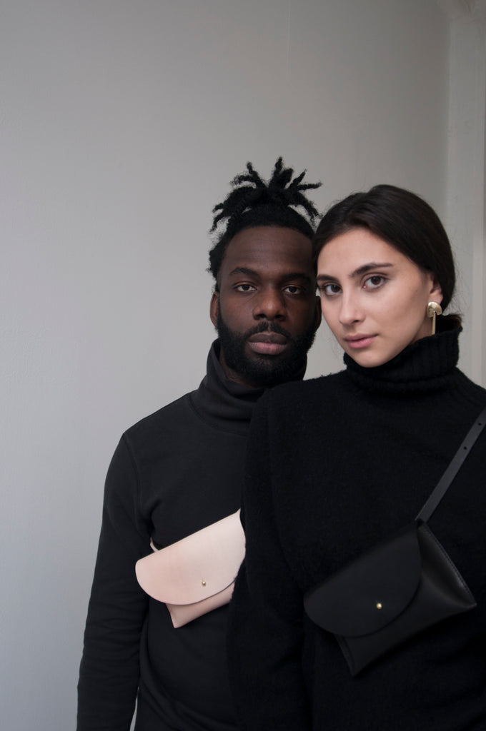 male model and female model wearing black turtlenecks and Glare Slings