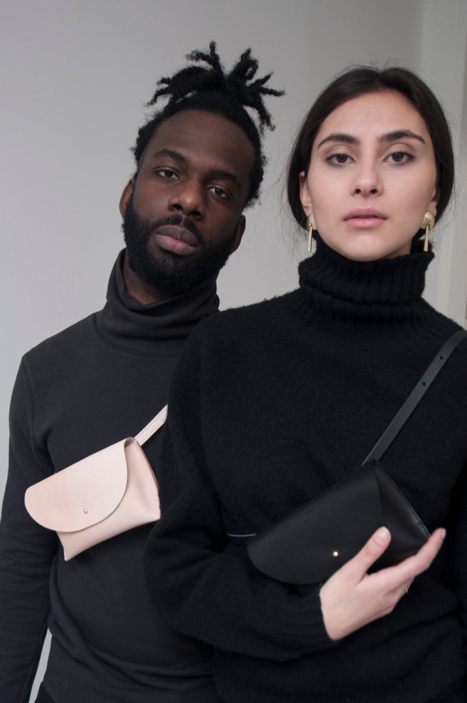 male model and female model wearing black turtlenecks and Glare Slings