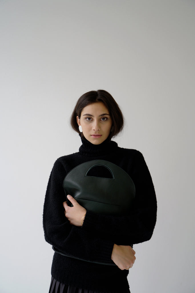 Female model with green leather bag