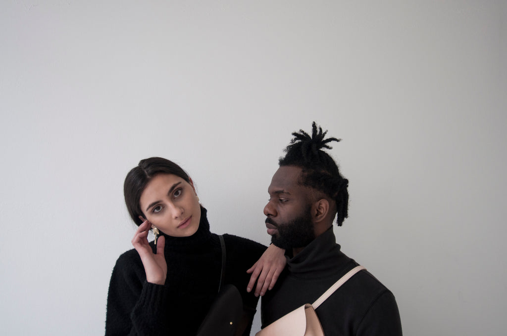 male model and female model wearing black turtlenecks and Glare Slings