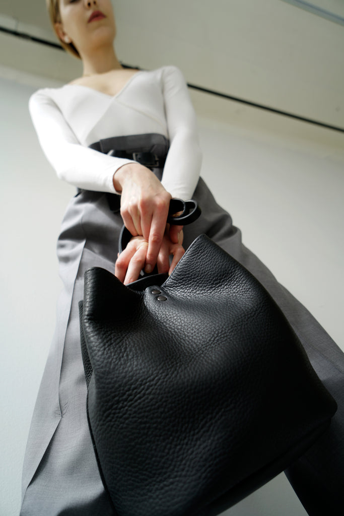 Female model with leather bag