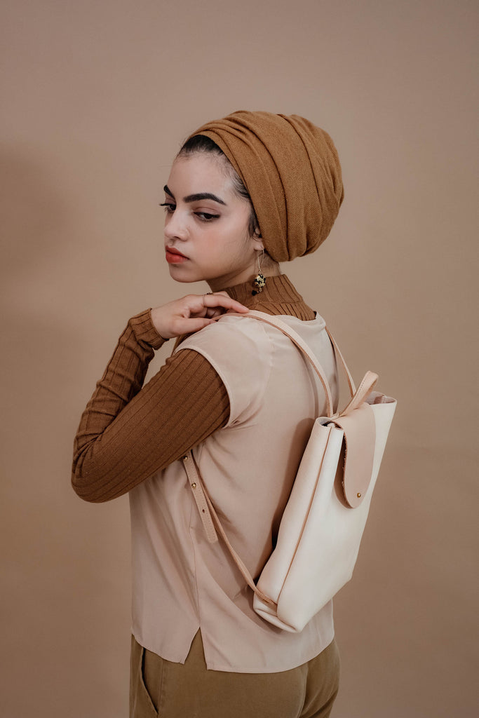 female model with leather backpack