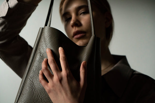 female model with leather tote bag