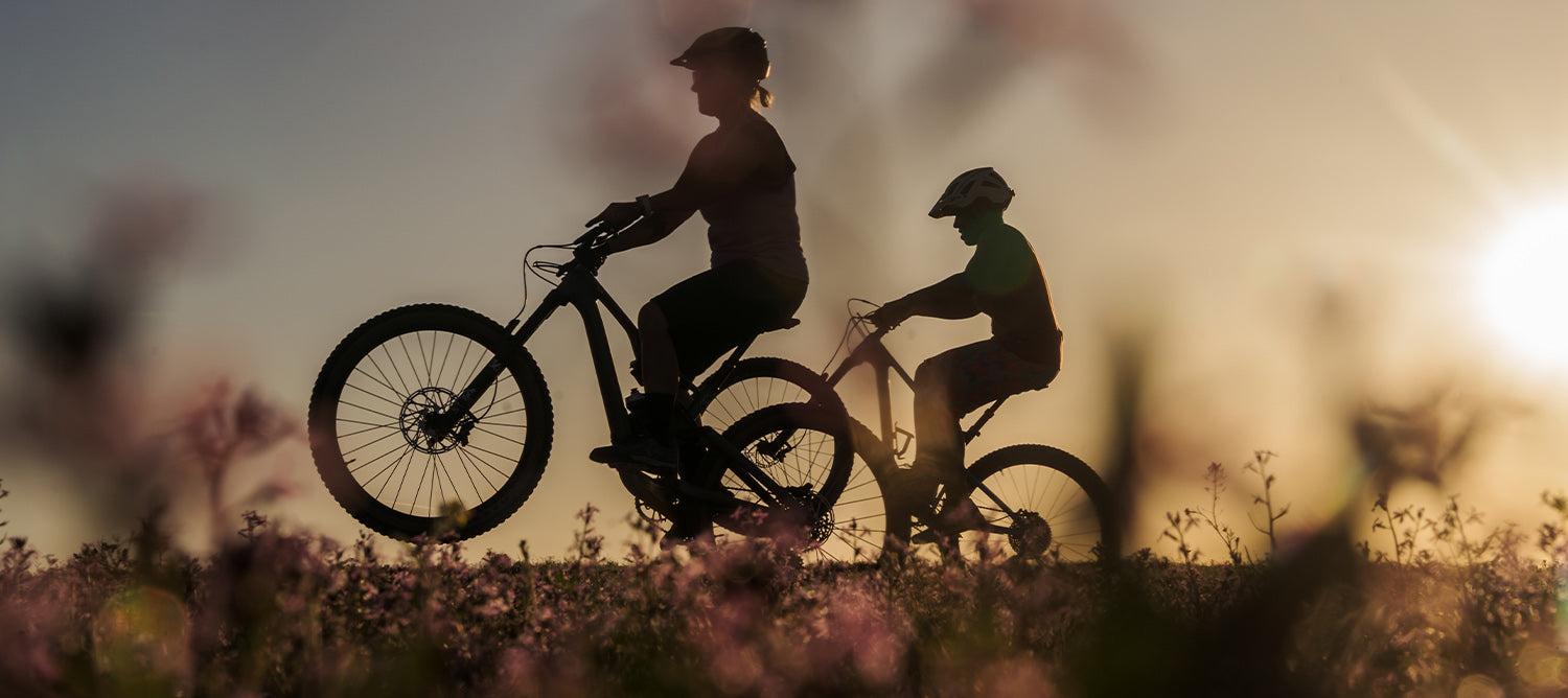 Women riding mountain bikes in the spring with flowers