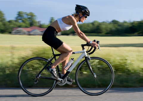 Athletic woman racing her bicycle