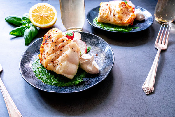 Chilean Sea bass with basil sauce on plate