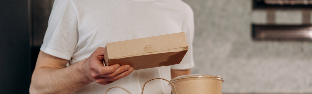 Someone holding a meal box