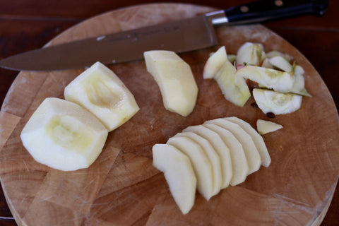 Quarter apple thinly sliced with chef's knife.