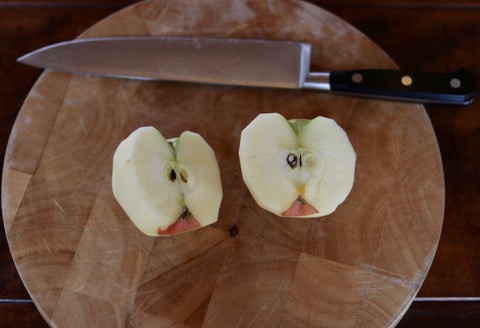 Chef knife and two apple halves