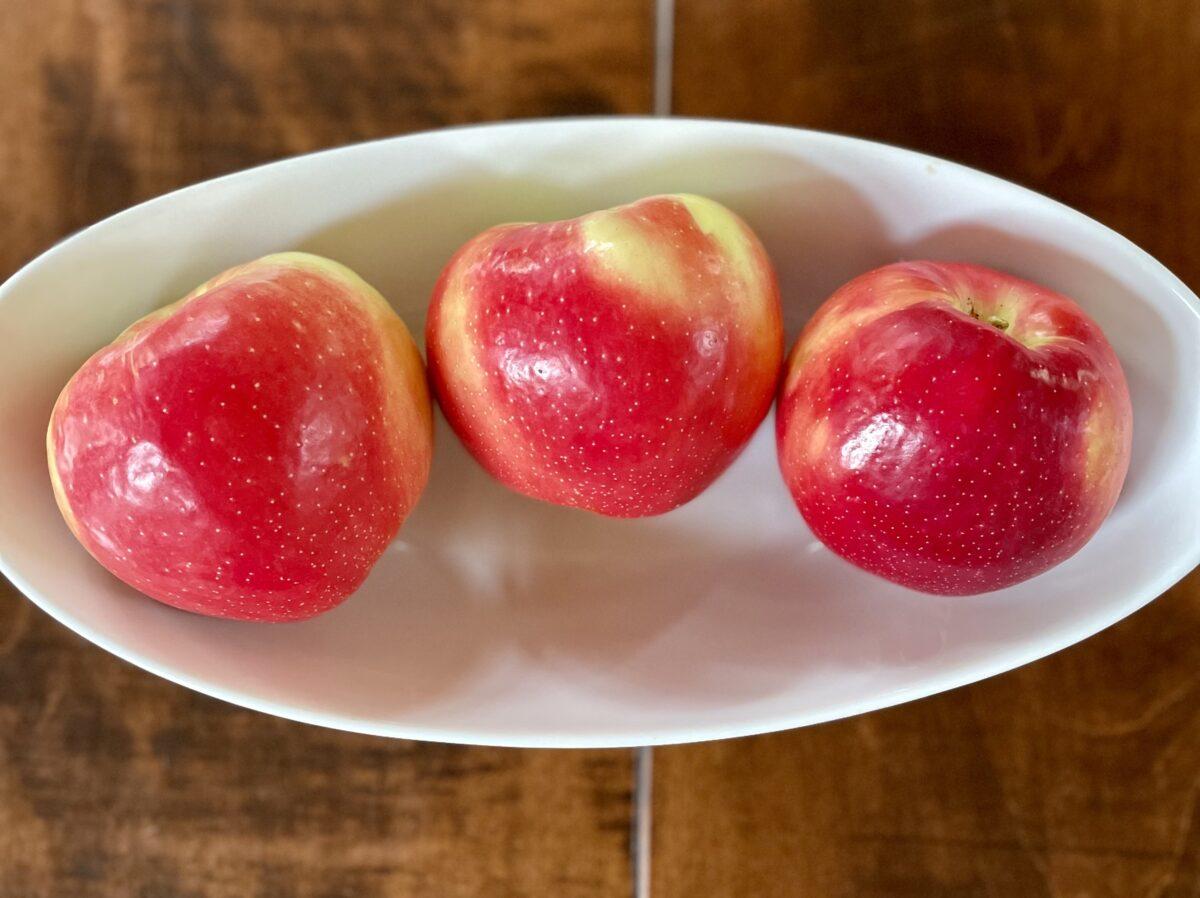 Bowl of three shiny SweeTango apples