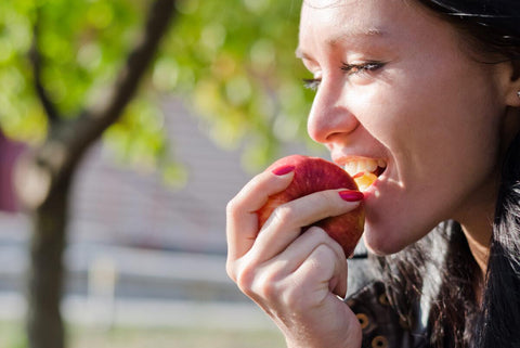 Woman eating Honeycrisp Apple
