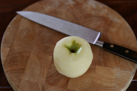 Chef's knife with a peeled apple