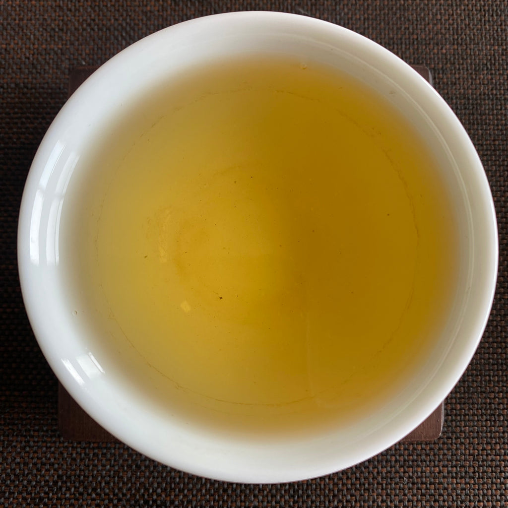 Dong Pian Oolong brewed tea in a cup