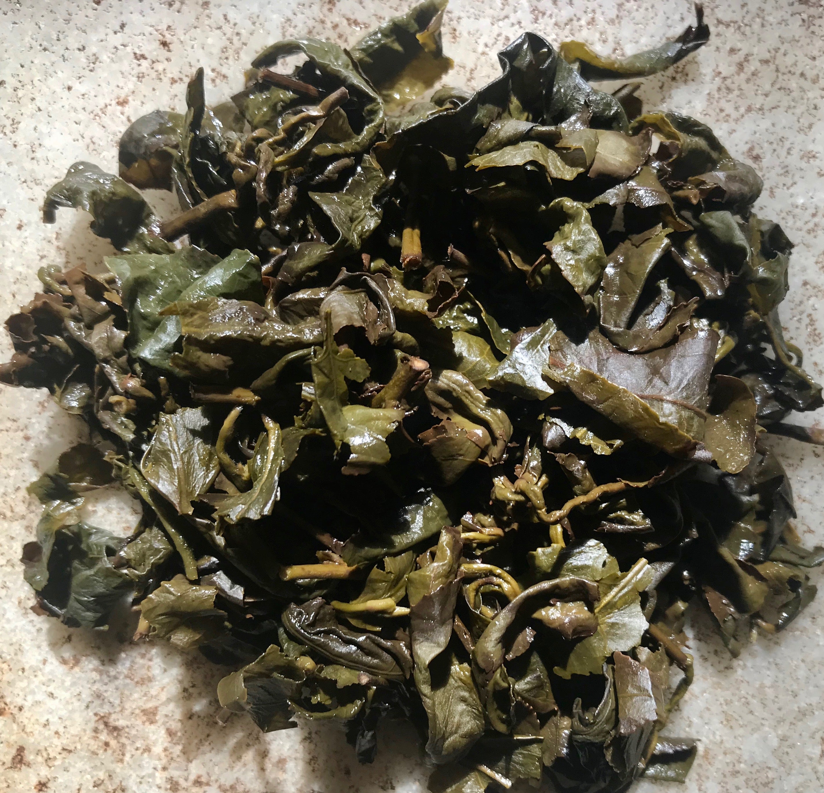 closeup shot of brewed Dong Ding Tie Guan Yin tea leaves
