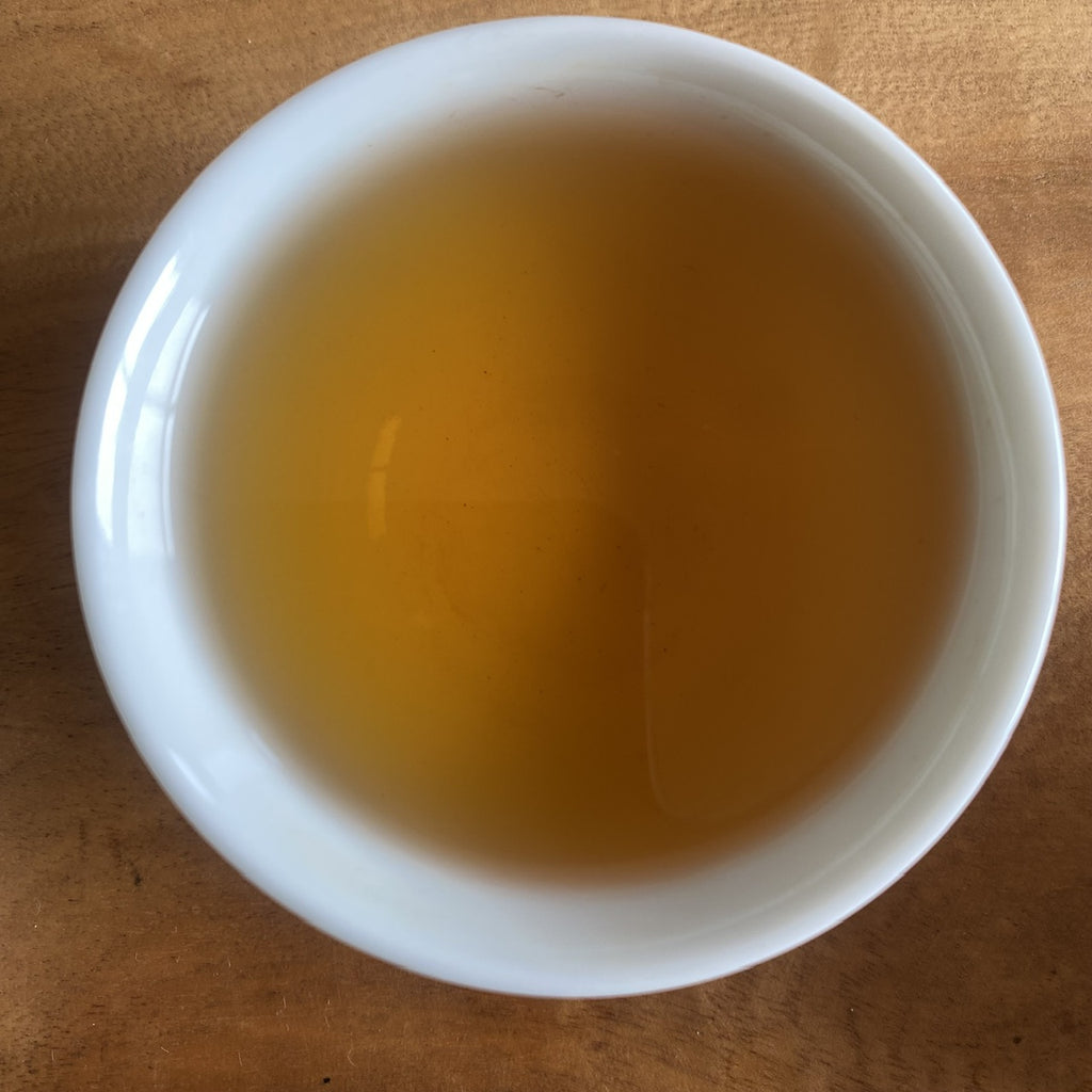 Tie Guan Yin Oolong brewed tea in a cup