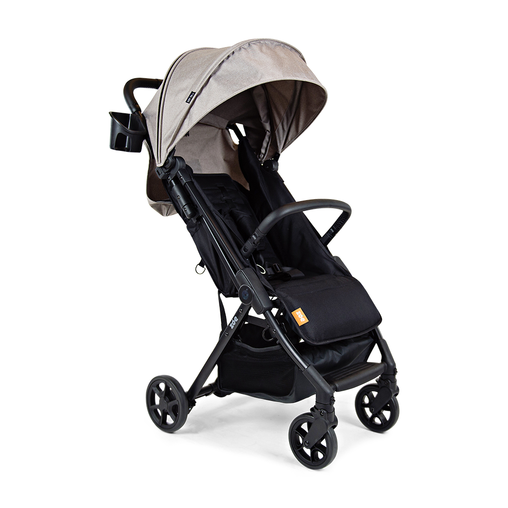 Black and grey travel stroller with a canopy, compact enough to fit in overhead storage on airplanes, ideal for active families.