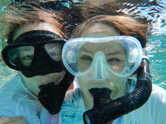 two ladies snorkeling in tahiti