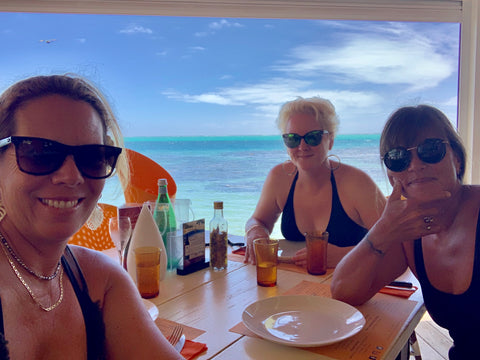 three beautiful ladies enjoying lunch by the sea in moorea