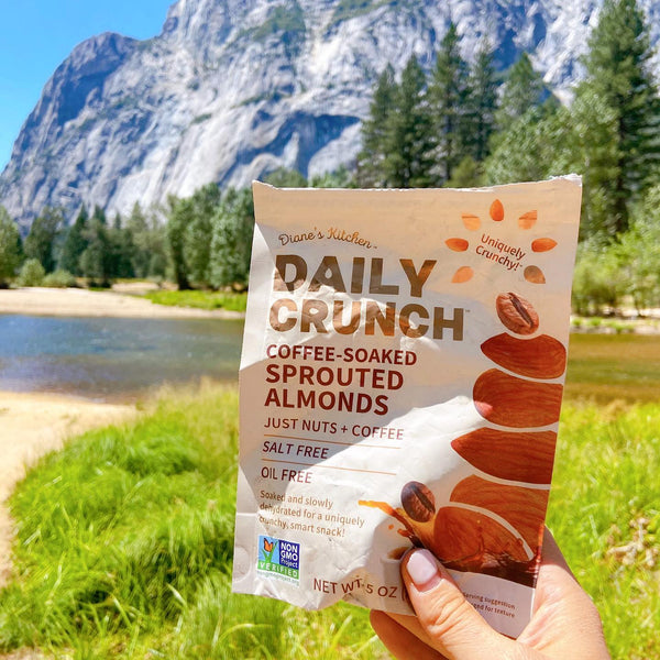 Daily Crunch Almonds Bag Over Scenic Mountain Landscape