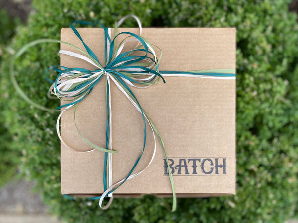 Batch Box resting on a green bush