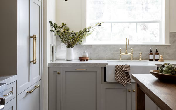 Emtek Polished Brass Wire Cabinet Pull on a Traditional Shaker Kitchen in Taupe