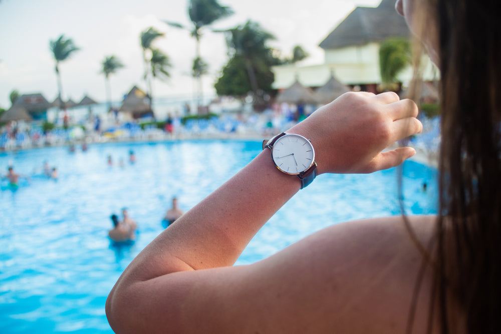 woman checking watch by pool