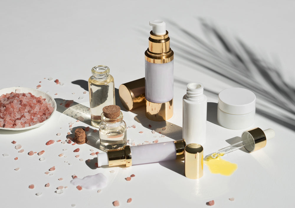 Image of makeup and skincare products on a white surface.