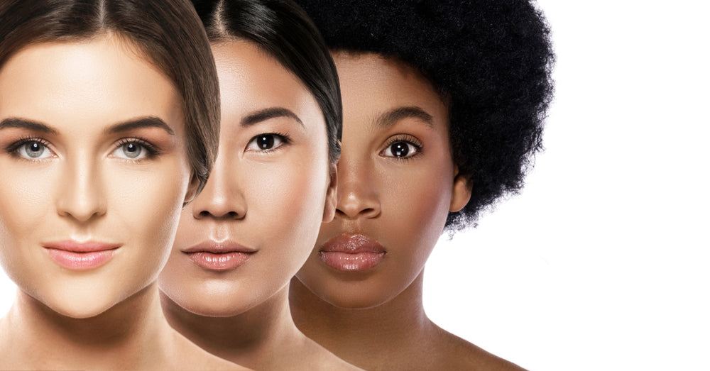 Close up of three women with different skin tones.