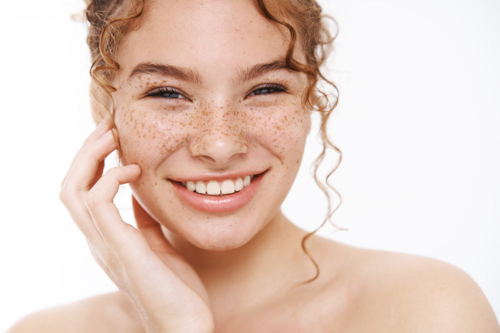 Smiling woman with freckles.