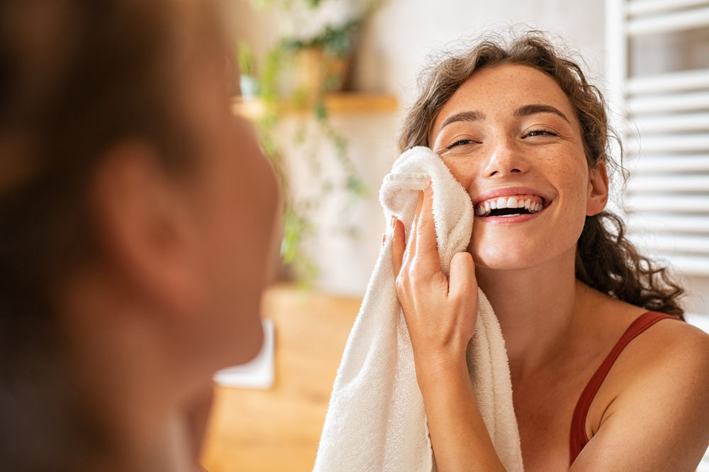 Woman patting her face dry.