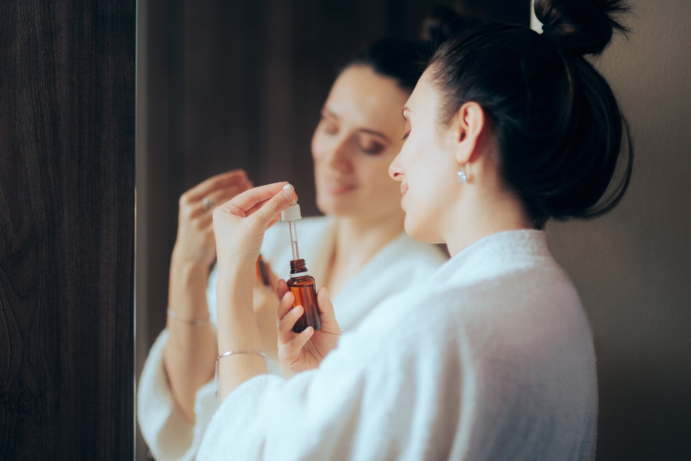 Woman using a serum.