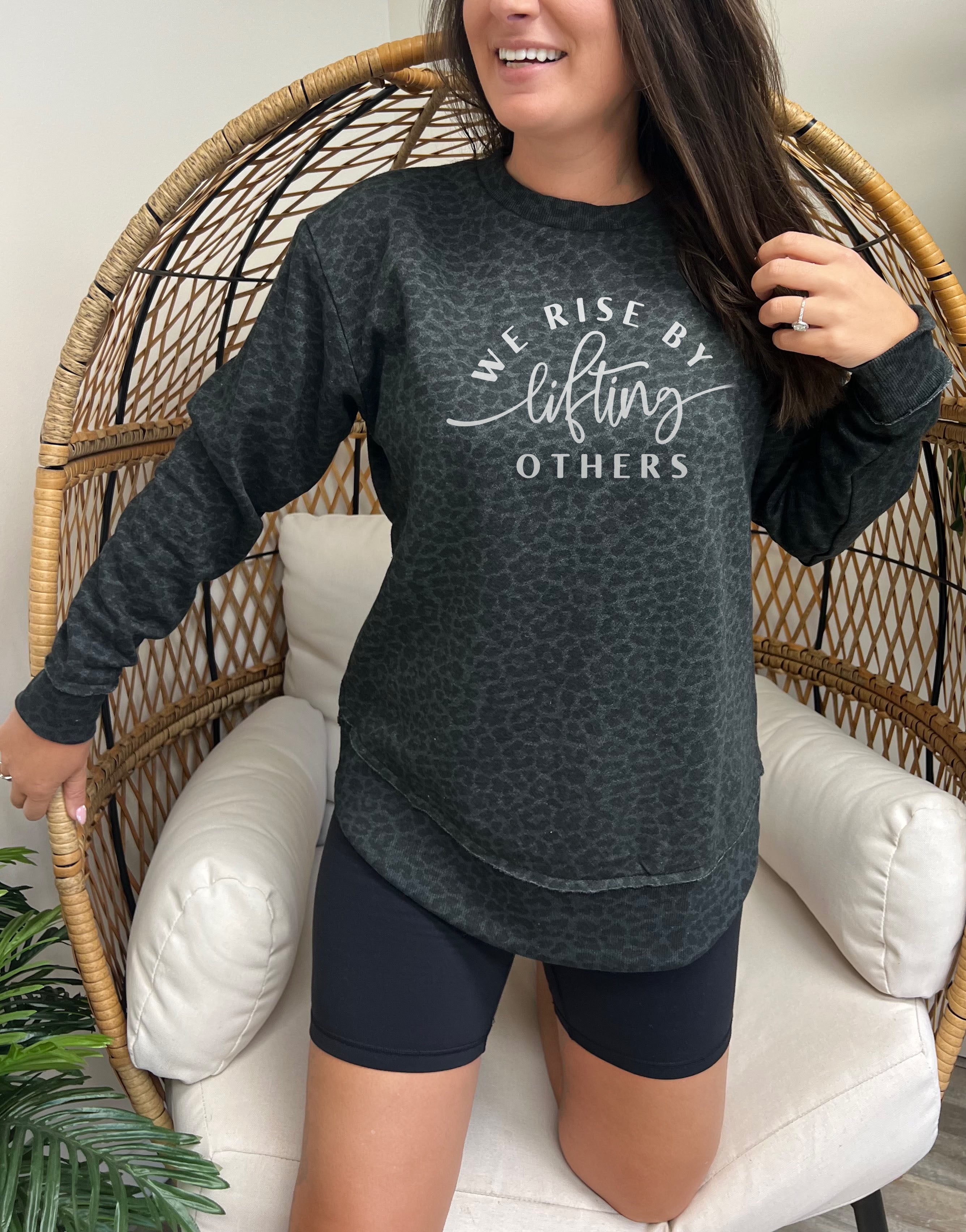 'We Rise by Lifting Others' Graphic Sweatshirt