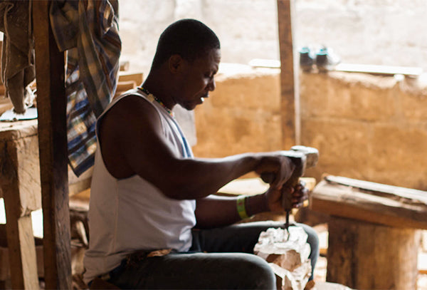 Ghanaian artisan carves furniture from wood