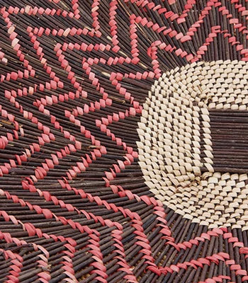 closeup of Zambian twig basket in pink